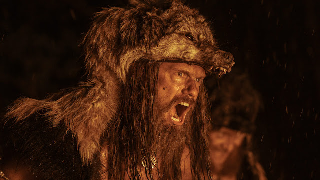 Alexander Skarsgard with a wolf skin on his head.
