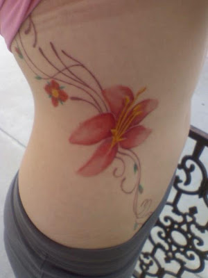 Tattoos For Girls With Flowers. rib tattoo women, star and