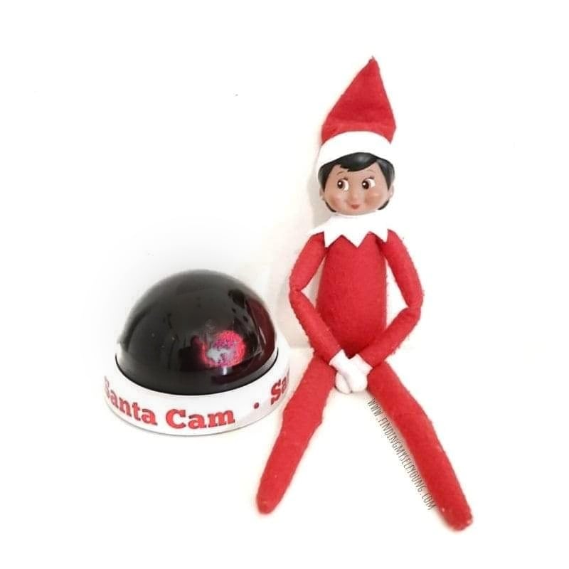 elf with santa surveillance camera