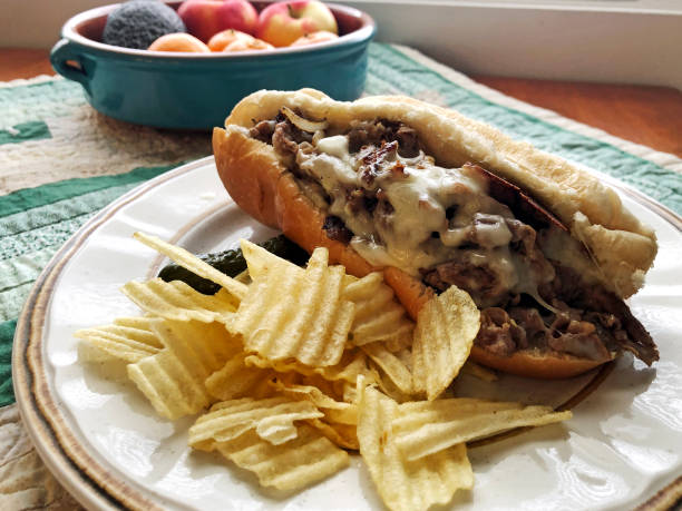 Steak and cheese sub sandwich ready to eat with chips