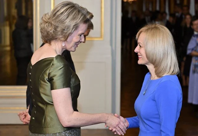 Queen Mathilde wore a green half sleeve silk satin blouse by Natan, and a green embroidered midi skirt by Natan