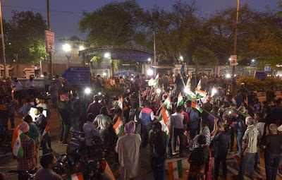 People gather outside Tihar jail during the execution of four men convicted of Nirbhaya rape and murder case