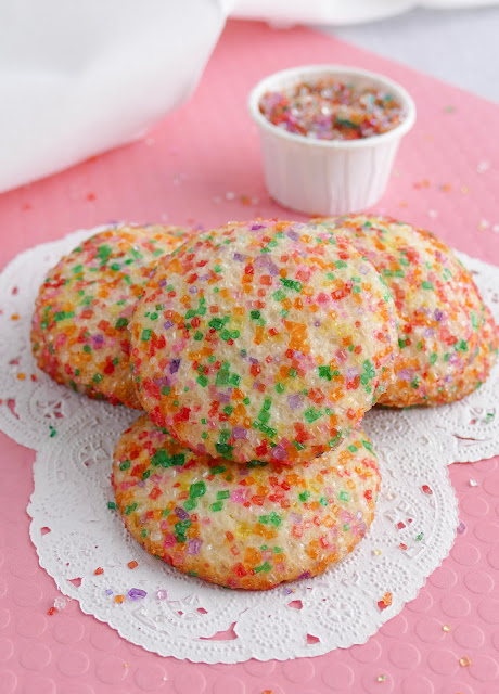 cookies in a messy stack on a white and pink background.