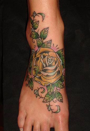 tattoos on back of leg. rose tattoos on ack.