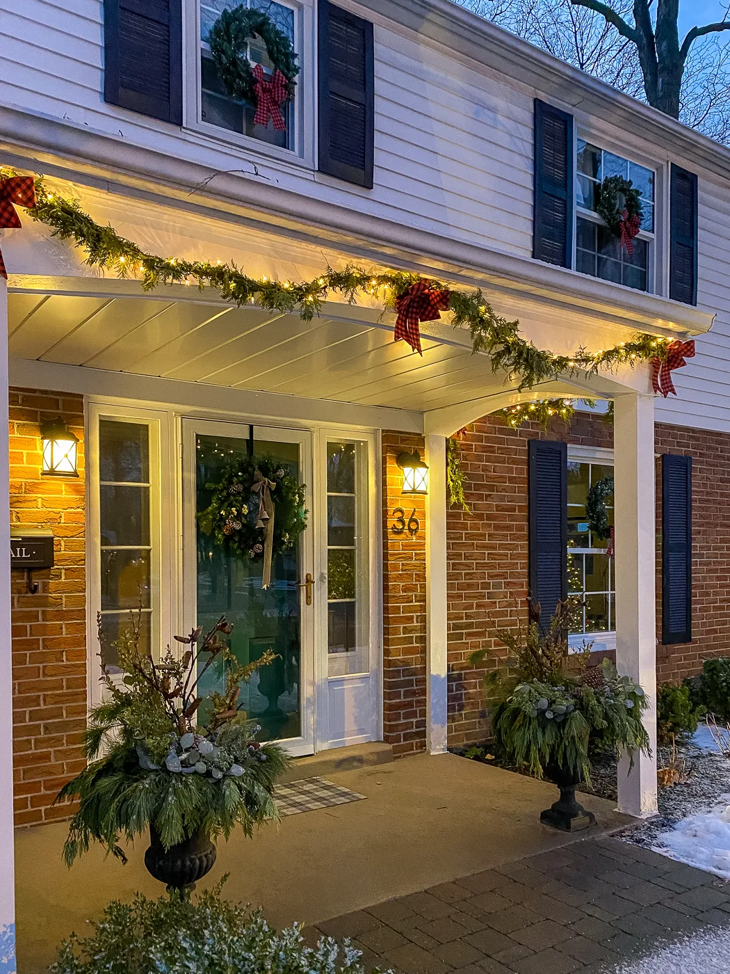 christmas front porch with green front door christmas wreath and christmas planters