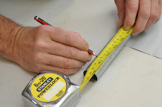 measuring and marking operation in sheet metal manufacturing workshop