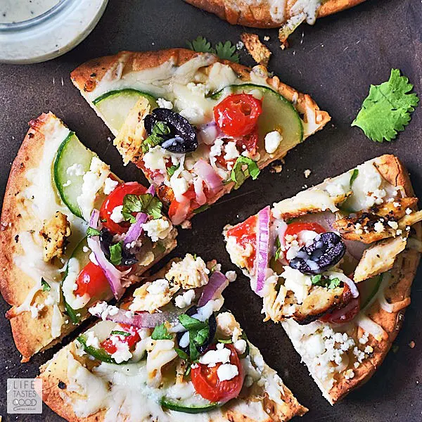 Individual Greek Pita Pizza sliced into 4 pieces