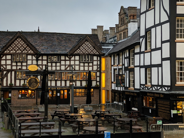 Tudor black and white building with tables outside