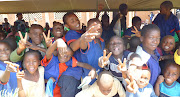 School children pose and make the ubiquitious peace sign (peace salima kids int lit day )