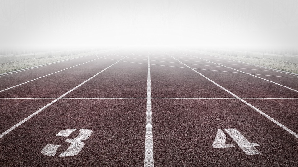 Empty running track and shrouded by fog