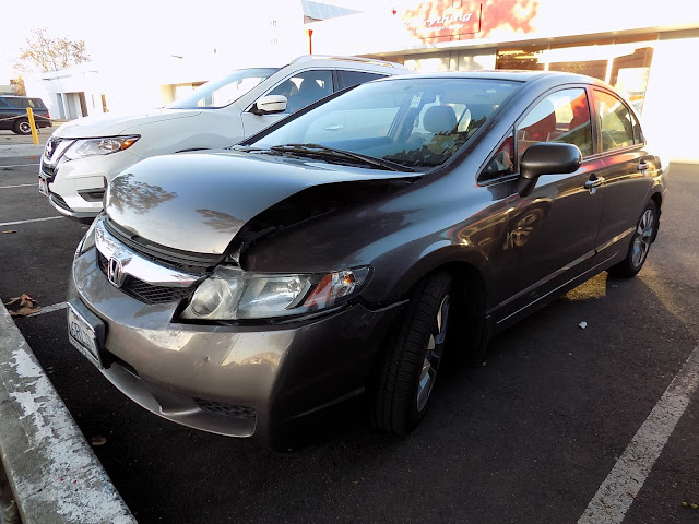 Honda Civic with damaged hood, bumper & fender before repairs at Almost Everything Auto Body.