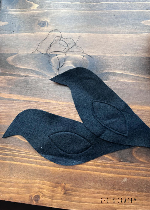 Sew wings on each side of the crow.