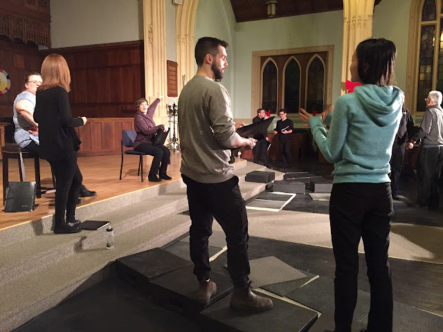 Stairwellers help the tech crew focus lighting by posing patiently