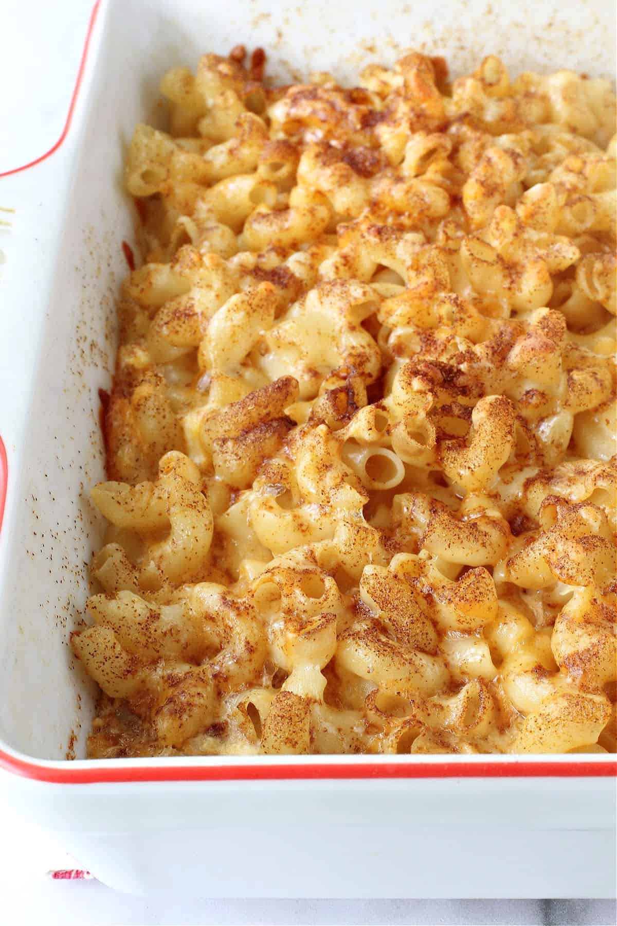 Baked Macaroni and Cheese in a red-rimmed casserole dish.