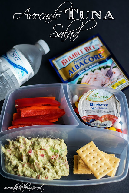 A picture of a child's lunch container with the tuna salad, carrot sticks, apple sauce and crackers.  