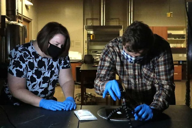 Assistant Professor of Physics Kerri Donaldson Hanna works with undergraduate student Adam Bedel in her lab preparing fibers for this NASA mission.