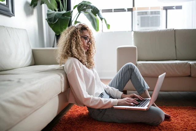 women working from home looking on her laptop for fitness ideas