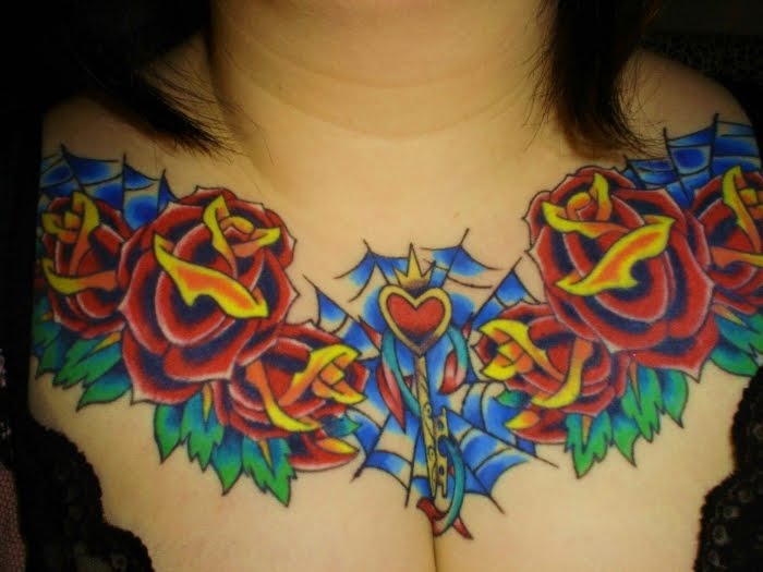 heart tattoos on chest. Heart and roses chest tattoo.