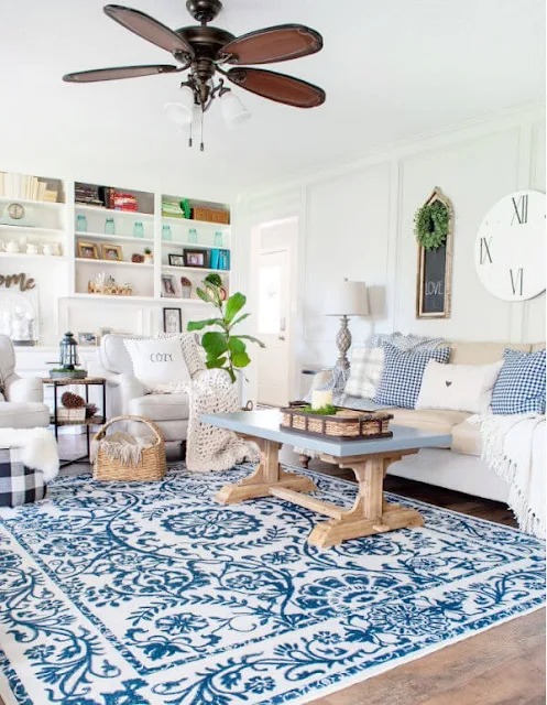 DIY Beautify living room with blue rug, light sofa and chairs and pillows and throws