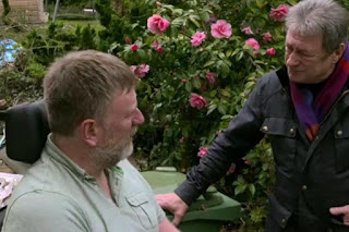 Alan speaks to Chris in the garden