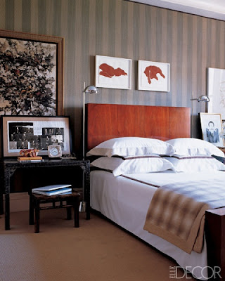 wood headboard, masculine bedroom, tailored bedding, warm interiors, art in the bedroom