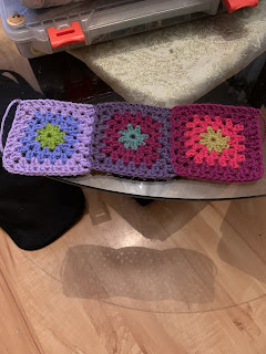 3 joined granny squares, the first 2 already described above, The furthermost one on the right consists of (center to outer rounds) 1 round of lime (dark moss), 2 rounds of pomegranate (dark pink), and 2 rounds of boysenberry (raspberry pink).
