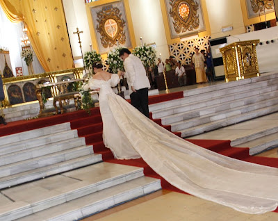 Mar helps his bridetobe to the altar as the wedding ceremony begins