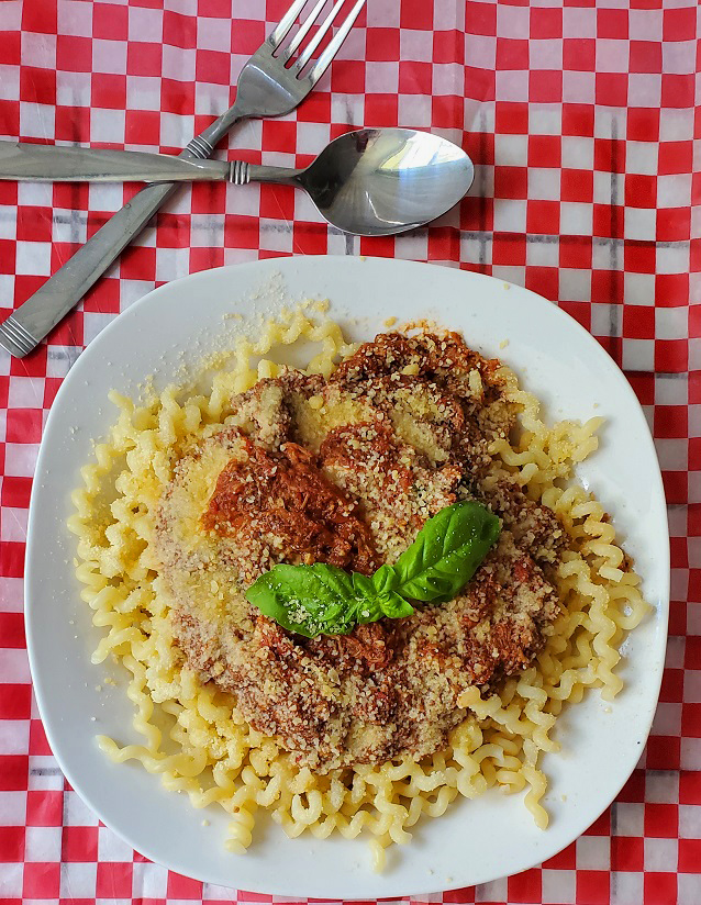 this is a spiral style spaghetti called fusilli with a pork sauce on top