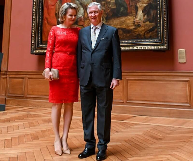 Queen Mathilde wore a red lace dress by Natan Couture. Giorgio Armani clutch. Christine Bekaert Lotus stud gold earrings