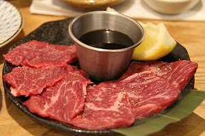 Well-marbled beef slices with au jus sauce