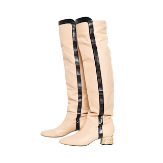 Vintage cream colored Chanel Go-Go boots with black and gold details.