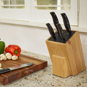 wooden knife block filled with black plastic rods