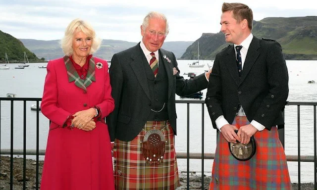 Duchess wore a waist-cinching red coat with a tartan lapel and tan heels. Camilla added a sapphire and diamond brooch