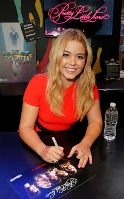 Actress Sasha Pieterse wearing a red dress