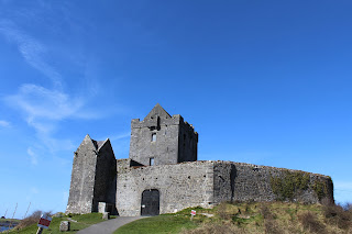 Tower House set on a hill against a blue sky