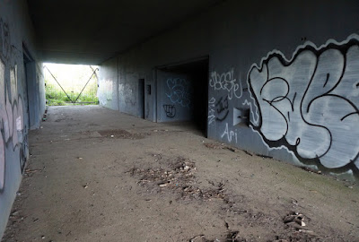 Looking into the interior corridor of Battery Harris East with entrances to rooms on either side of corridor