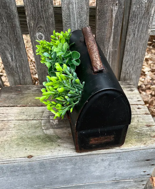 Photo of vintage metal lunchbox repurposed as an herb planter.