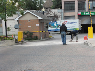 Two workers fixing exit gate arm