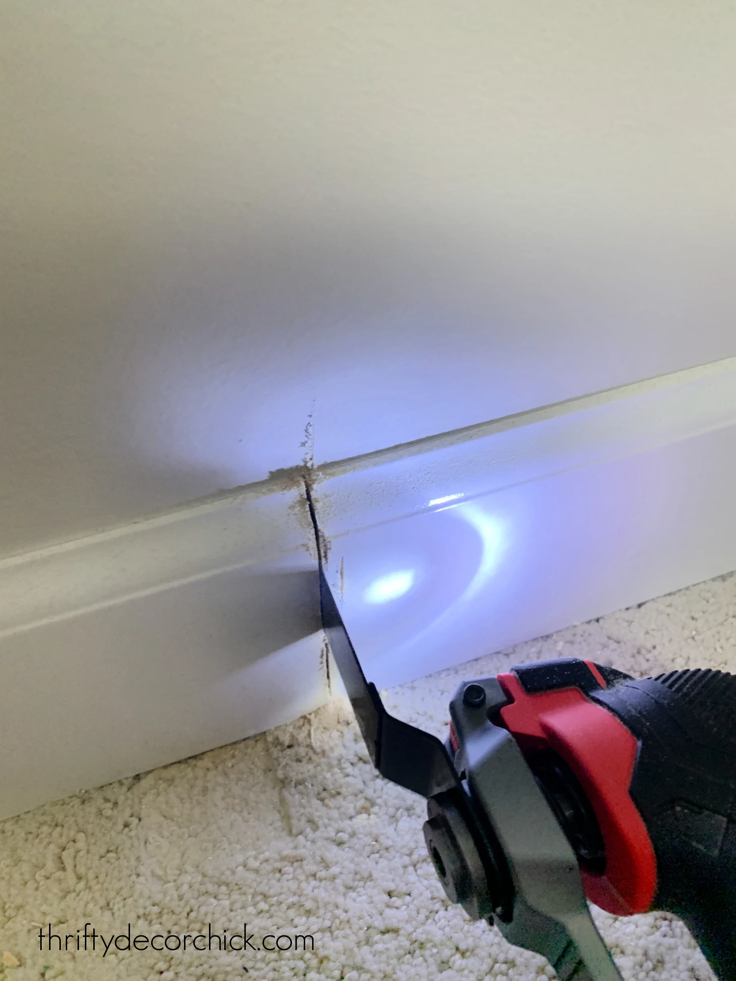 cutting baseboards with saw