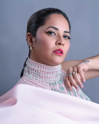 Anasuya Bharadwaj looks stunning in her latest floral saree and gown photoshoot, showcasing elegance and style.