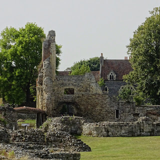 A photo showing various crumbling and ruined walls of the old abbey.  In the background are trees and the blue skies of a sunny and hot day.  Photo by Kevin Nosferatu for the Skulferatu Project.