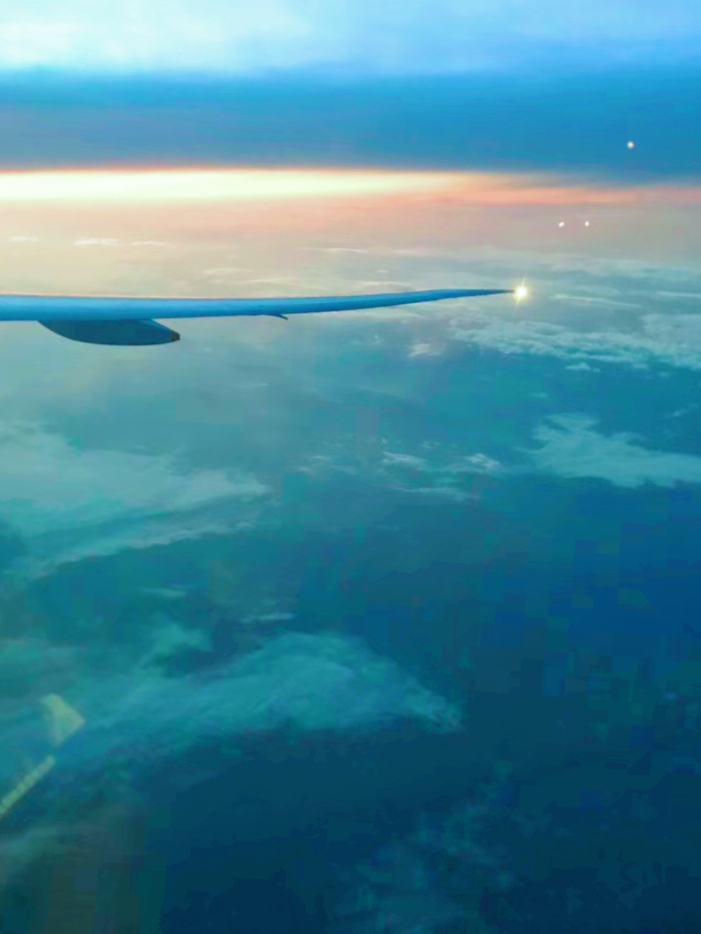 Great sunset views above the clouds outside the plane window