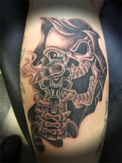 gangsta tattoo: Grim Reaper pointing an old-fashioned revolver