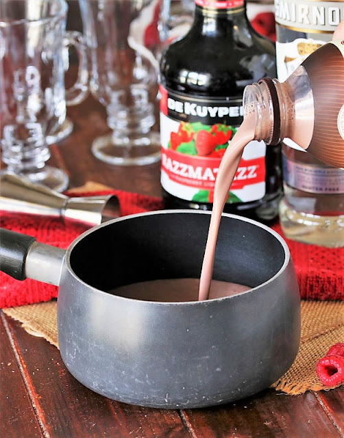 Pouring Chocolate Milk in a Saucepan Image