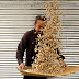 A man cleans peanuts outside a shop in Peshawar 