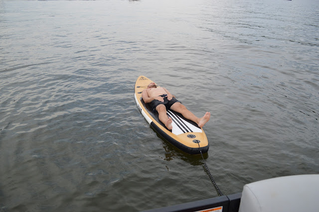 Dad laying flat on the paddleboard