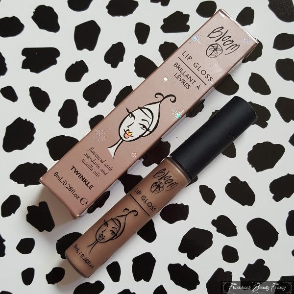 nude coloured lipgloss in tube next to box