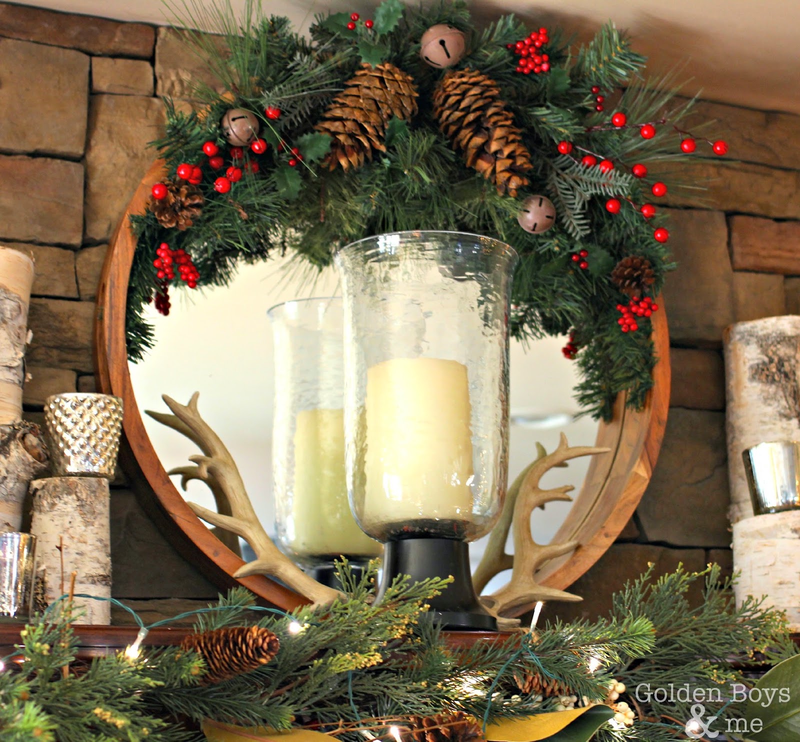 Round mirror with Christmas decor and antlers over stone fireplace in family room-www.goldenboysandme.com