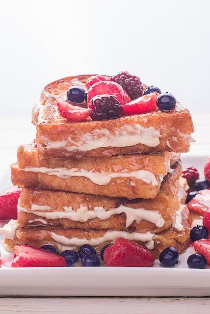 french toast stacked on a white plate.