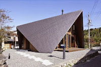 Origami House Design with A-Frame in an Old Village Surrounded by Mountains